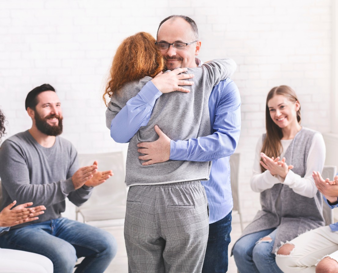 Two people supporting each other during a recovery program.