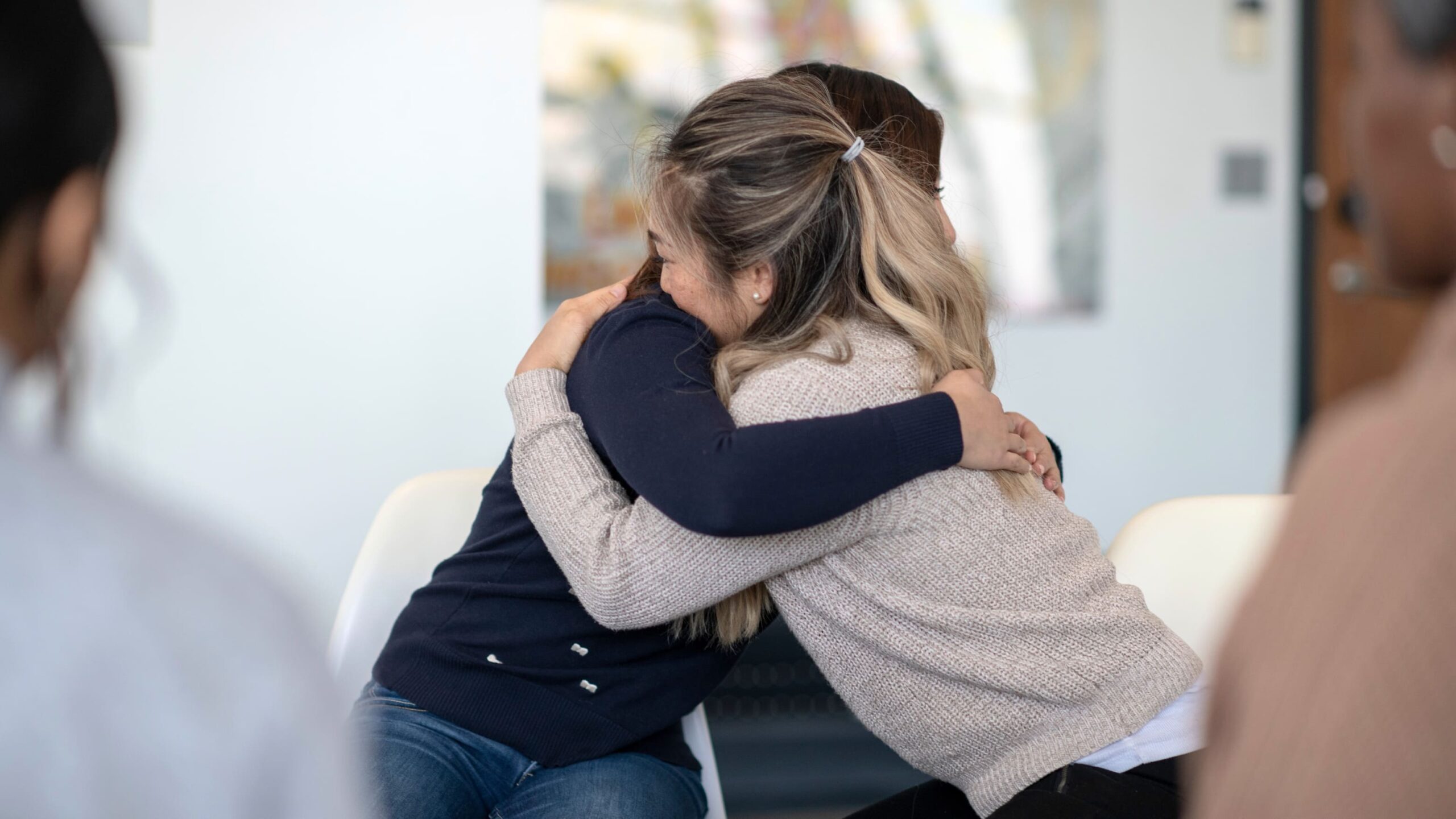 A woman hugs her loved one during a session of CBT in Atlanta.